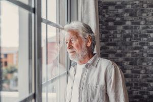 sad man looking out window