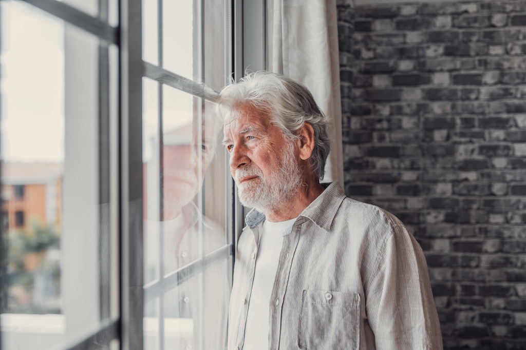 sad man looking out window